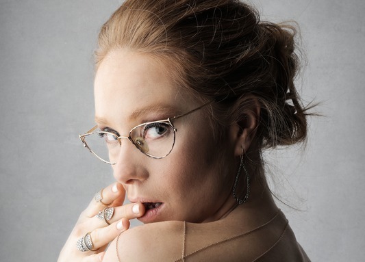 Woman wearing gold colored framed eyeglasses