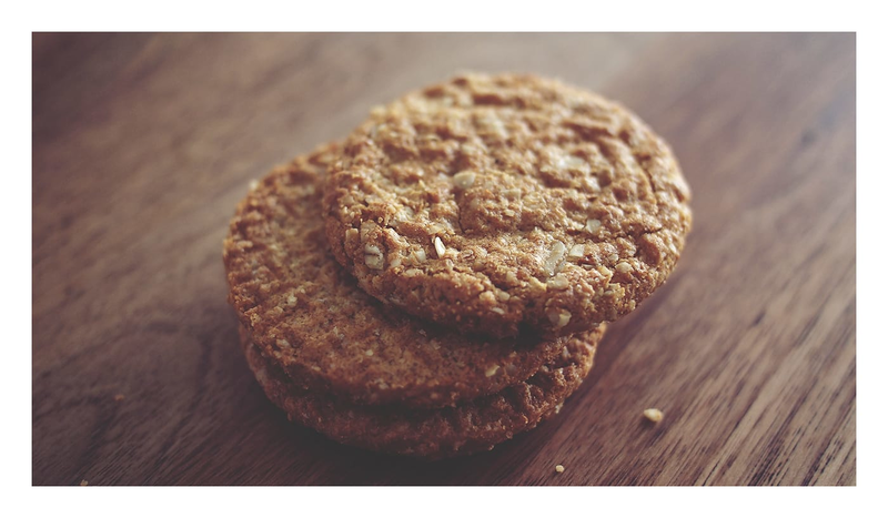 An image of peanut butter cookies on a wooden cutting board