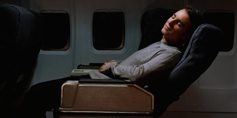 man sleeping on plane