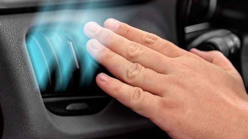 A man troubleshooting common automobile cooling system with his hand
